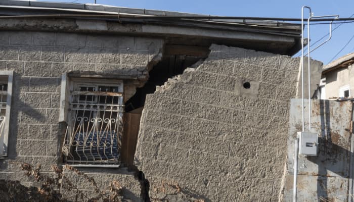 Damaged building from a storm. Have you included earthquake insurance in your policy?
