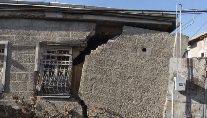 Damaged building from a storm. Have you included earthquake insurance in your policy?